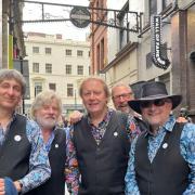5 members of union jack on Mathew Street, Liverpool in blue paisley shirts and waistcoats