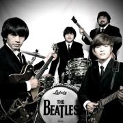 G-Pluck, four piece Beatles tribute band from Indonesia dressed in black suits with their instruments.